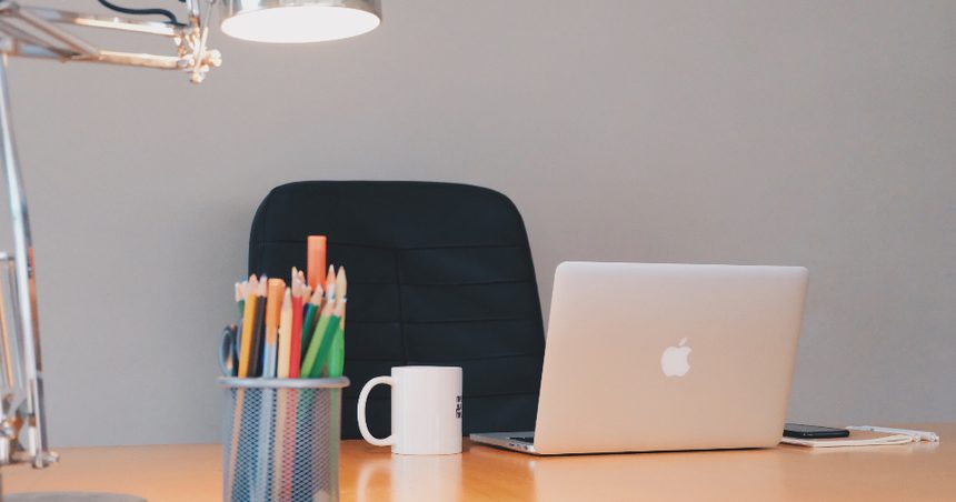 Clean digital workspace with a laptop on a desk, representing a modern AI-enabled B2B commerce platform that answers buyer questions from real catalog data